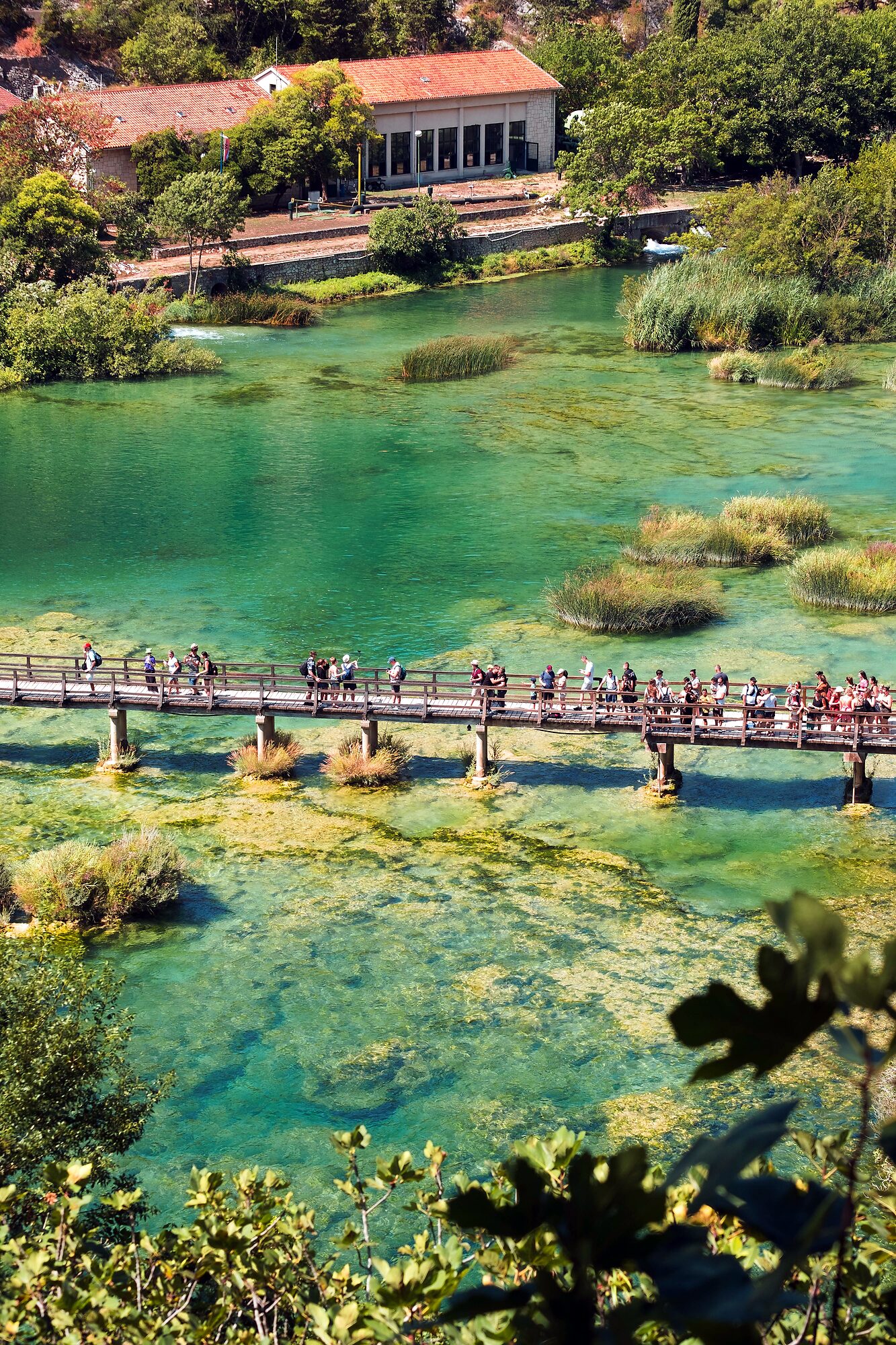 Footbridge crossing the turquoise Krka river near the Eco-Campus